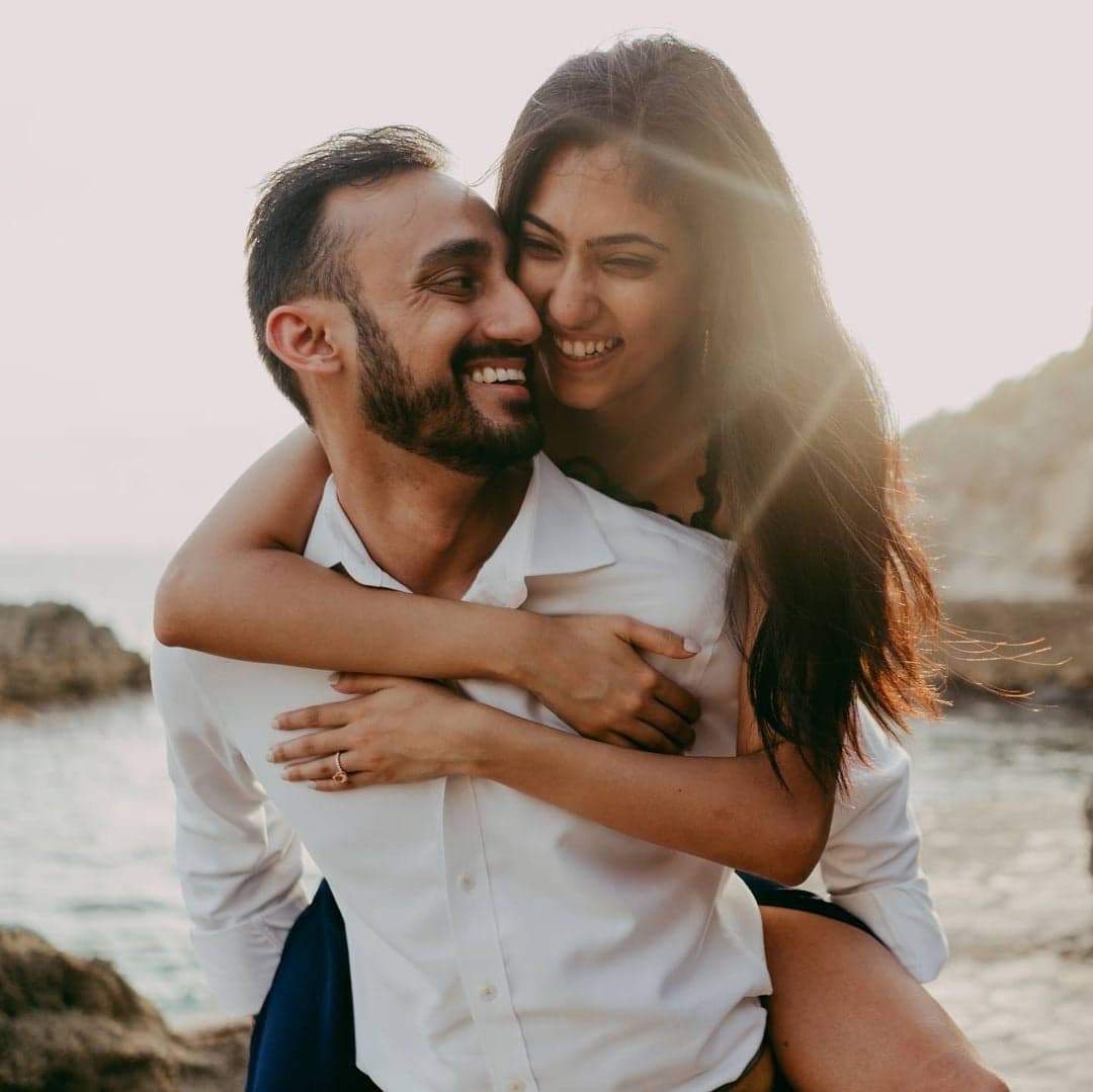 A couple embracing by the water