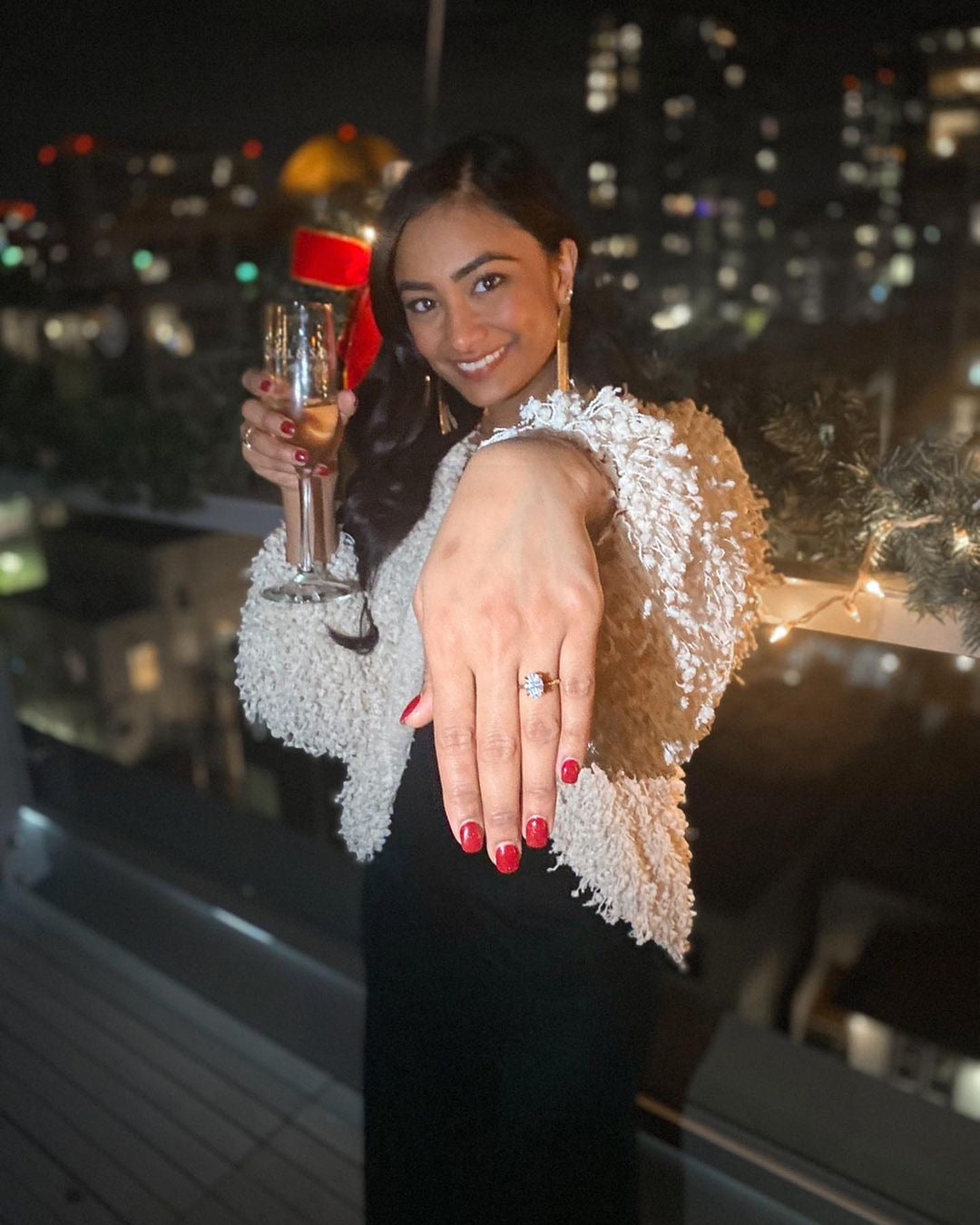 A woman showing her new engagement ring